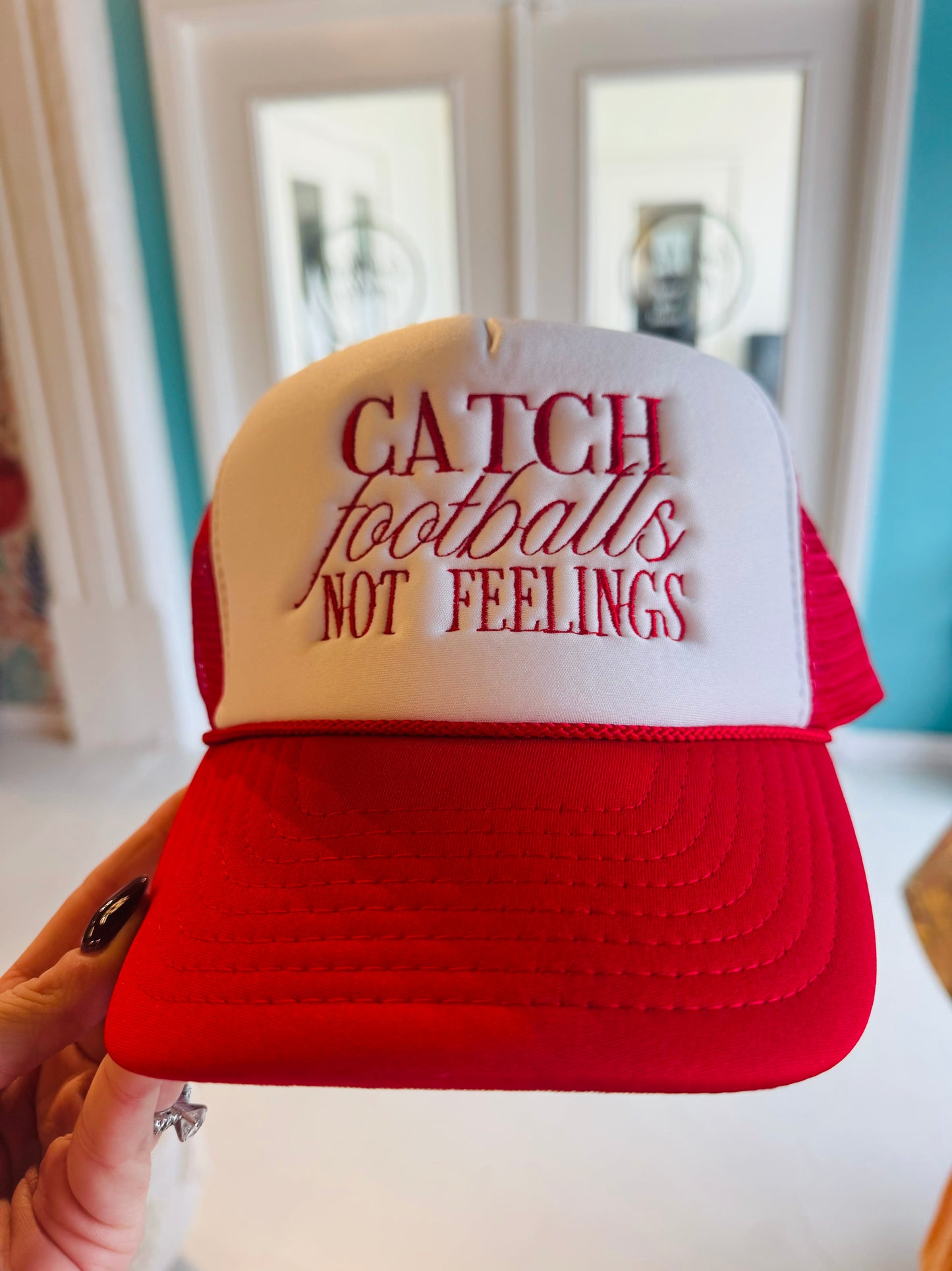 Catch Footballs Not Feelings trucker hat